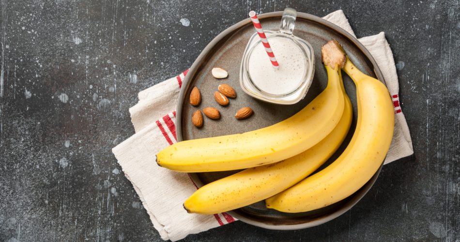 Banana smoothie and bananas on a plate