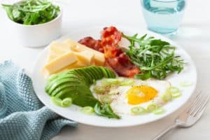 healthy keto breakfast: egg, avocado, cheese, bacon