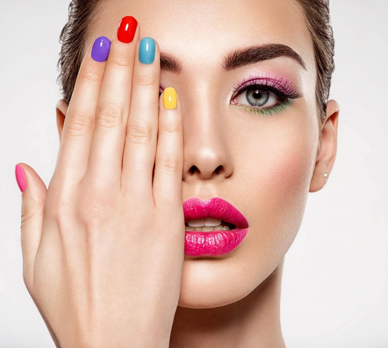 Beautiful fashion woman with a colored nails.